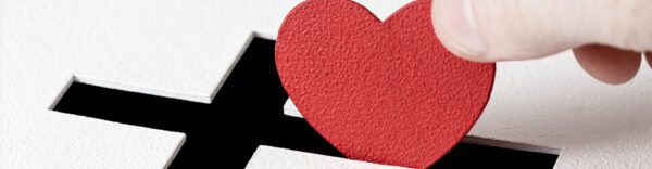 A red heart sitting on top of a white box.