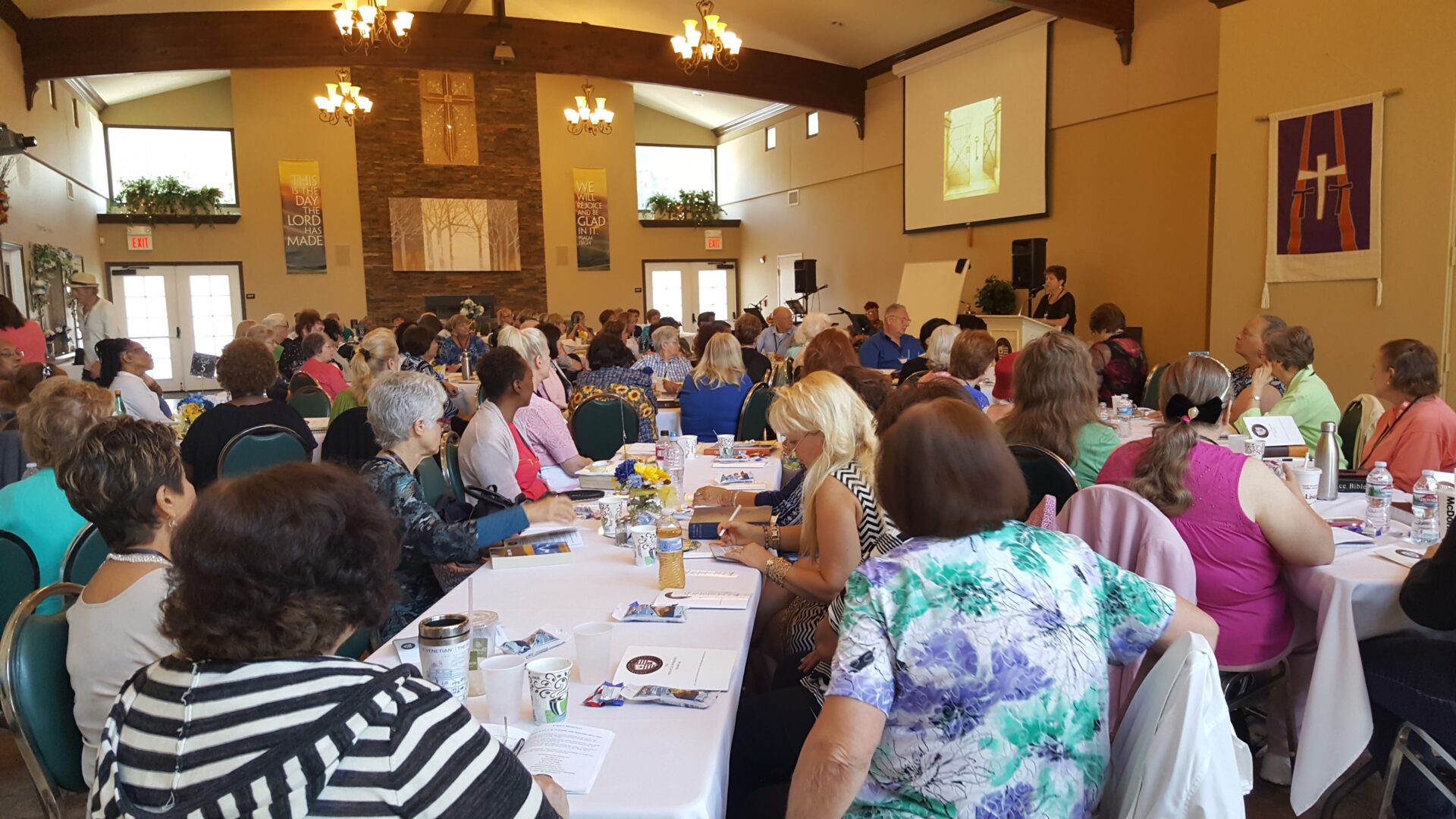 A large group of people sitting at tables.